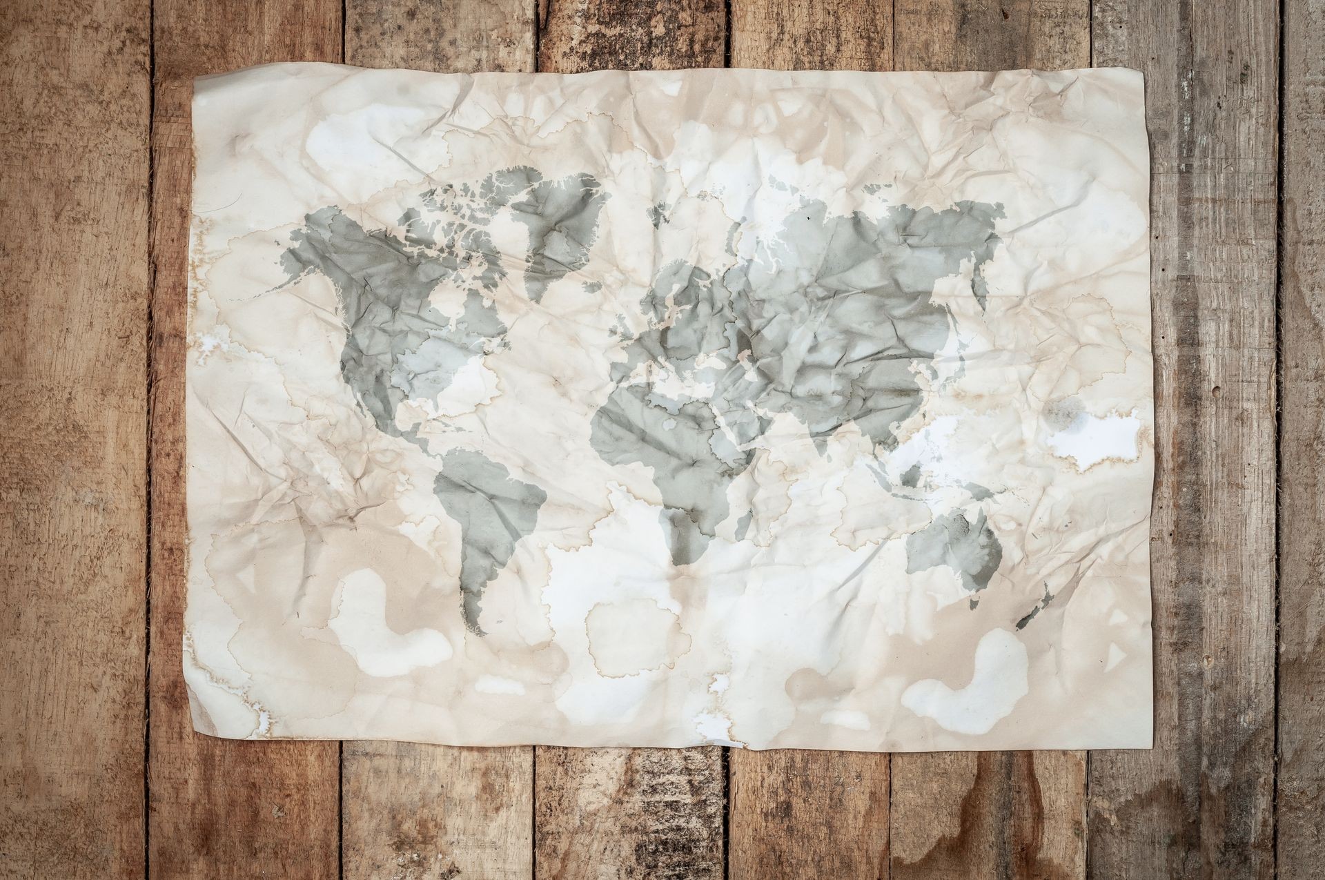 World map on vintage and retro yellow paper with wooden background